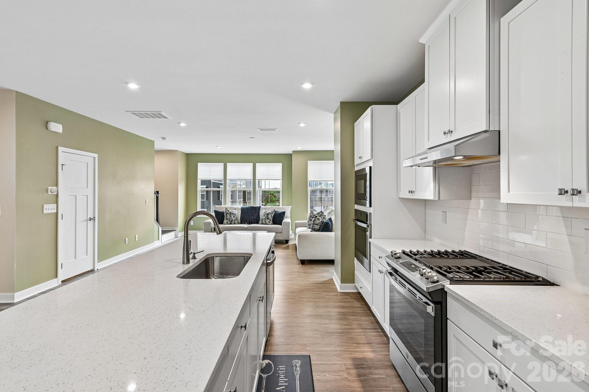 957 Portrush Lane Tega Cay, SC 29708 - Photo 10 of 39 a kitchen with stainless steel appliances granite countertop a lot of white cabinets and a refrigerator