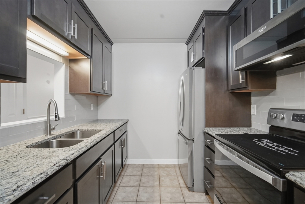 36 Maple Crest Circle, Unit F Holyoke, MA 01040 - Photo 8 of 16 a kitchen that has a sink and a stove