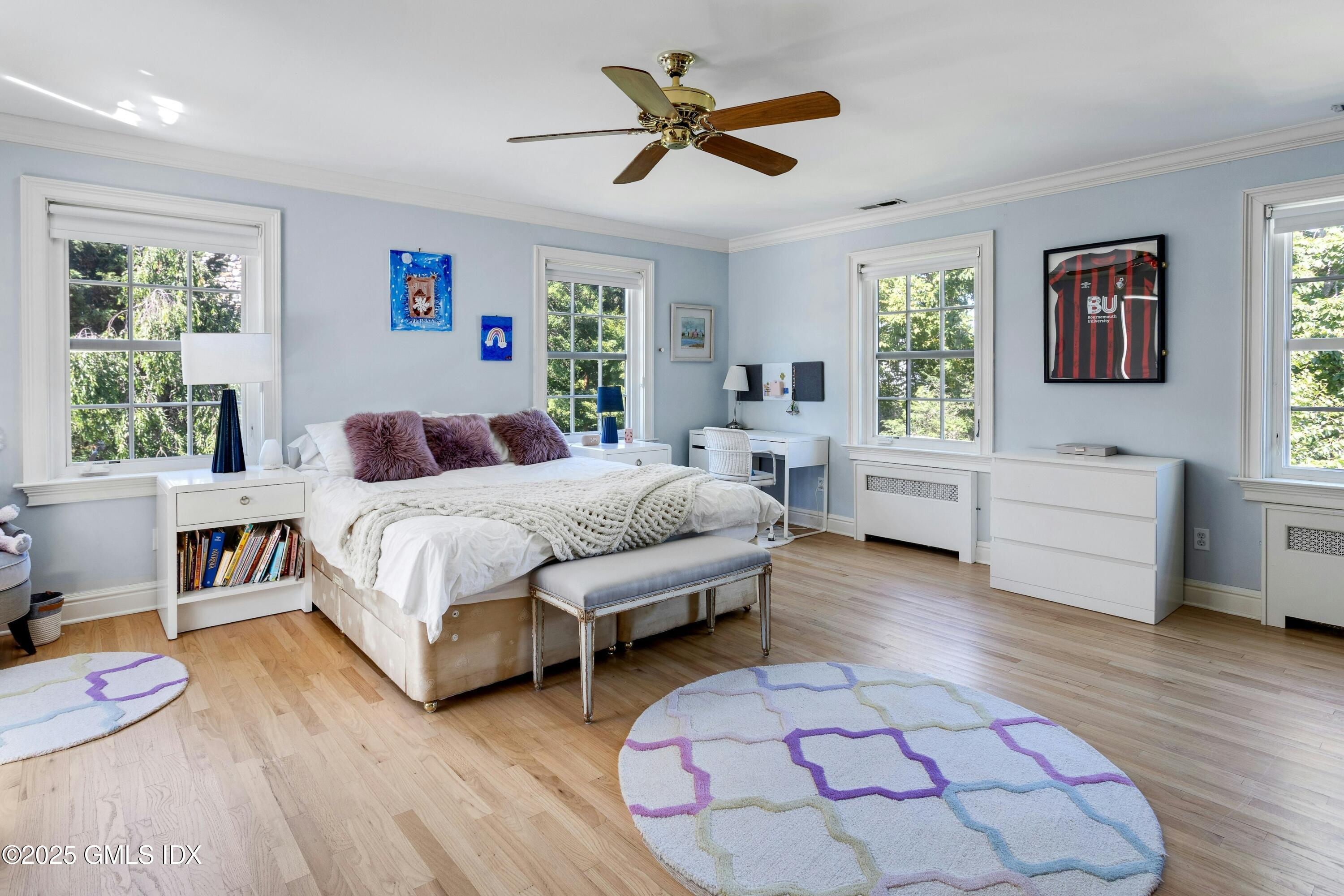 40 Willowmere Circle Riverside, CT 06878 - Photo 24 of 34 a spacious bedroom with a bed a couch and window