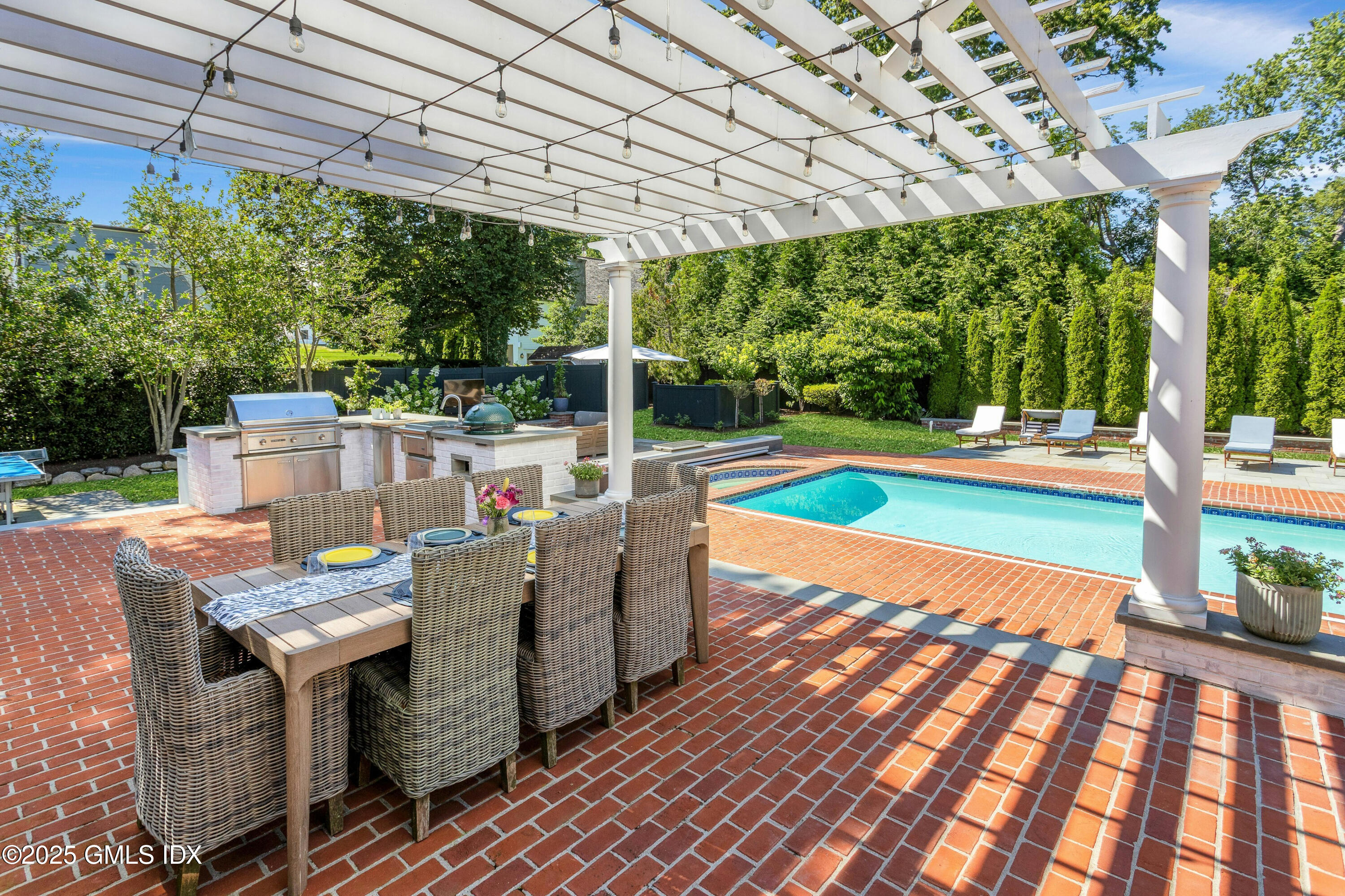 40 Willowmere Circle Riverside, CT 06878 - Photo 27 of 34 a view of a patio with table and chairs potted plants with wooden floor and fence