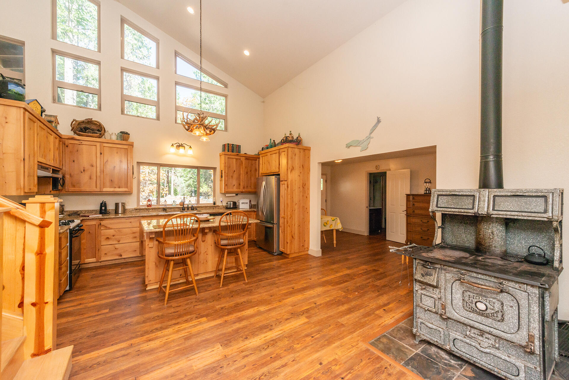 851 Mountain Aire Road Trinity Center, CA 96091 - Photo 3 of 54 a living room with furniture a fireplace and a dining table with wooden floor