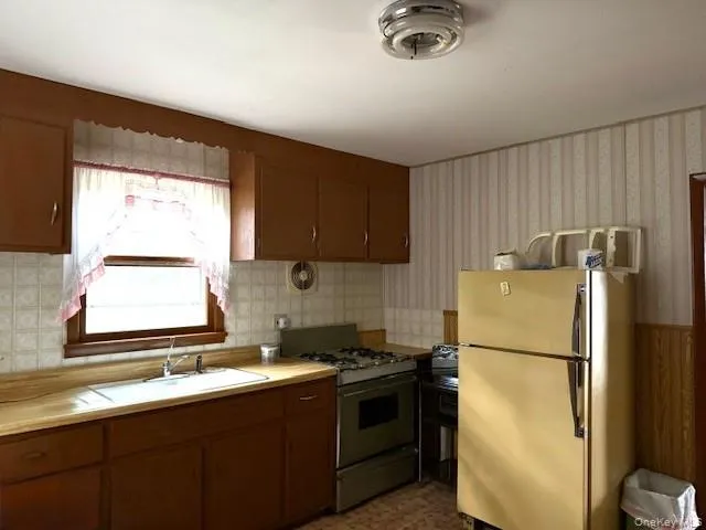 a kitchen with a refrigerator and a sink