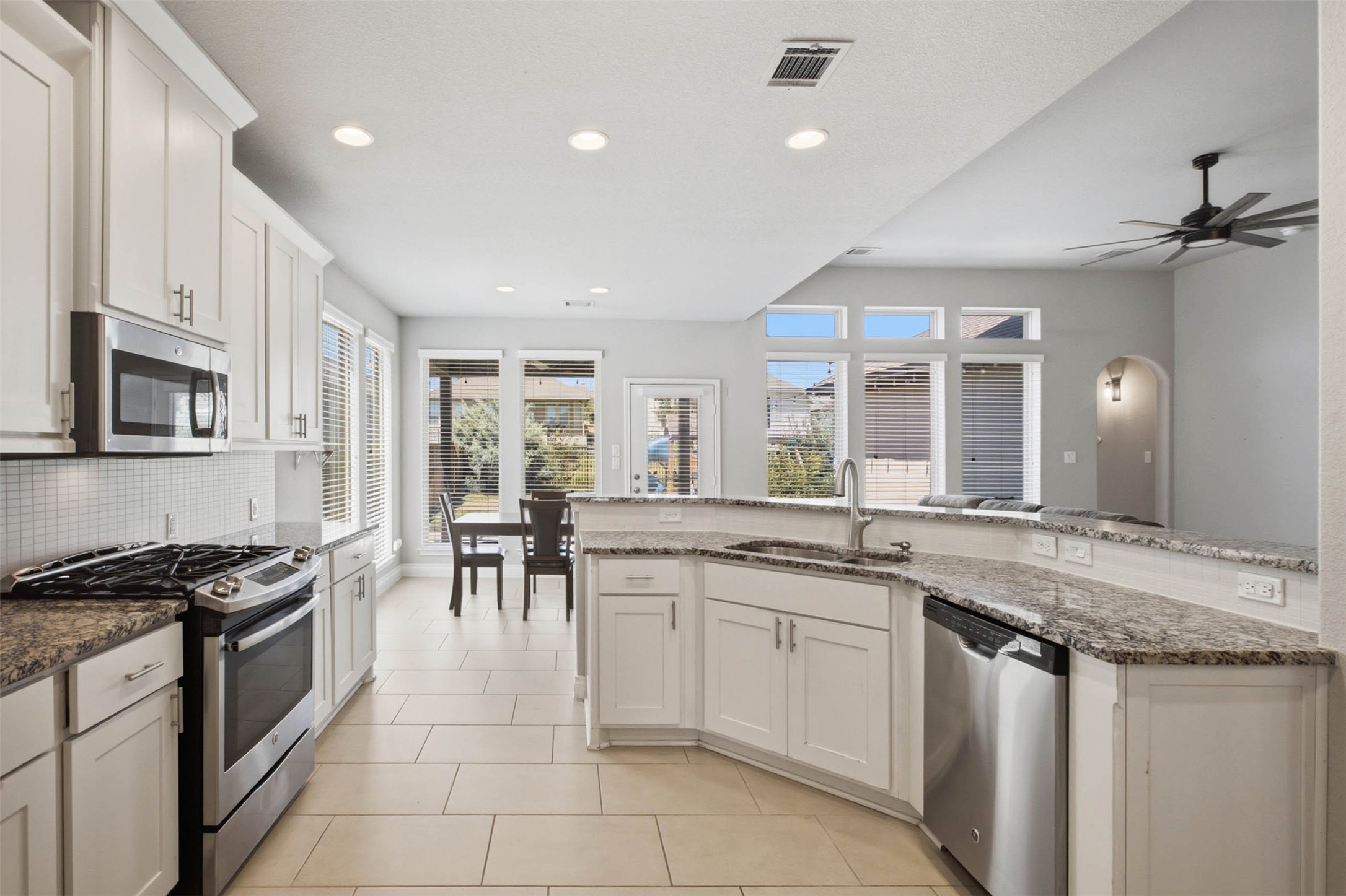 3101 Rabbit Creek Drive Georgetown, TX 78626 - Photo 7 of 38 Brightly lit open-concept kitchen features a large breakfast bar and ample cabinetry.