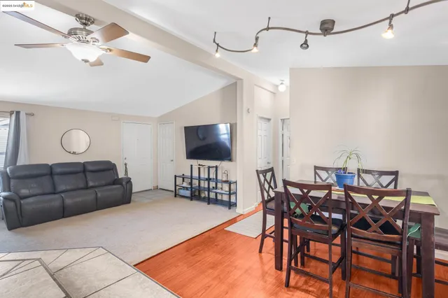 a living room with stainless steel appliances kitchen island granite countertop furniture and a couch