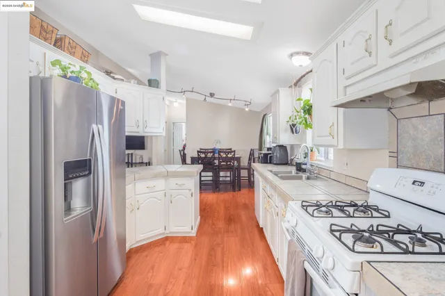 a kitchen with a sink stove and refrigerator