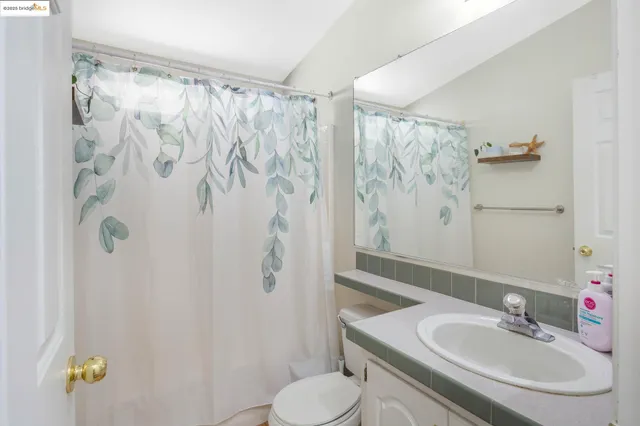 a bedroom with a bed a couch and a window