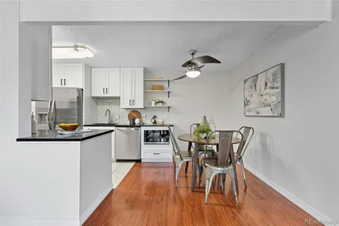 a kitchen with granite countertop white cabinets and stainless steel appliances