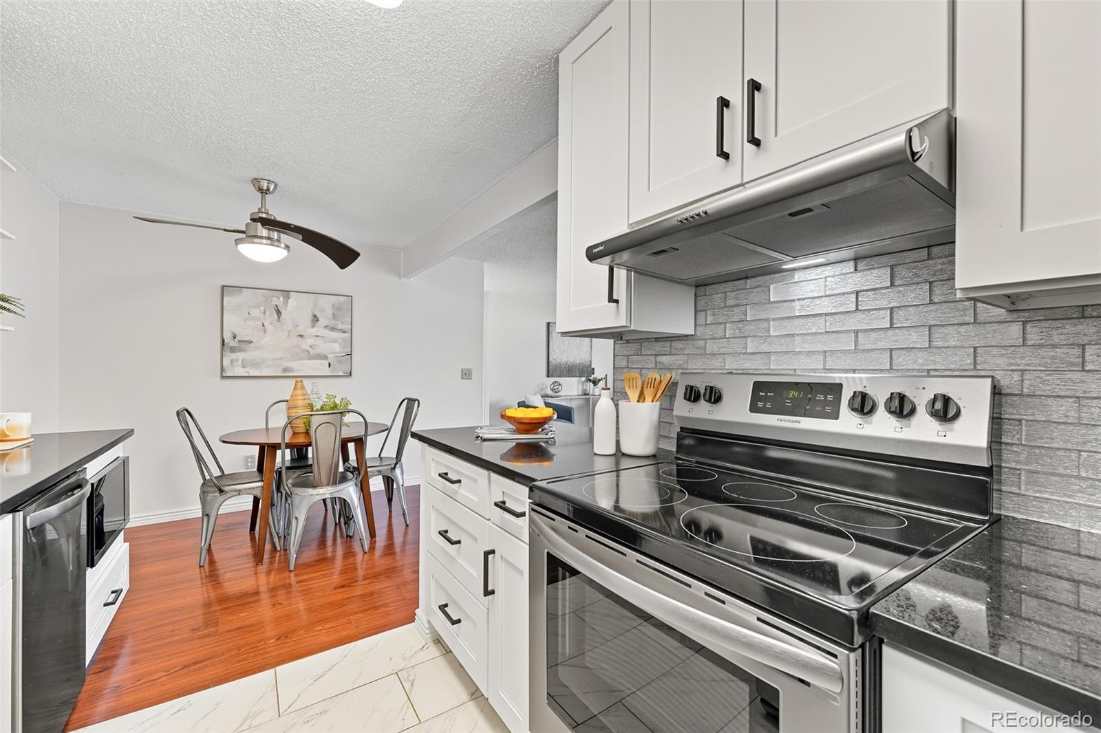 381 South Ames Street, Unit C204 Lakewood, CO 80226 - Photo 14 of 34 a kitchen with stainless steel appliances granite countertop a stove a sink and a refrigerator