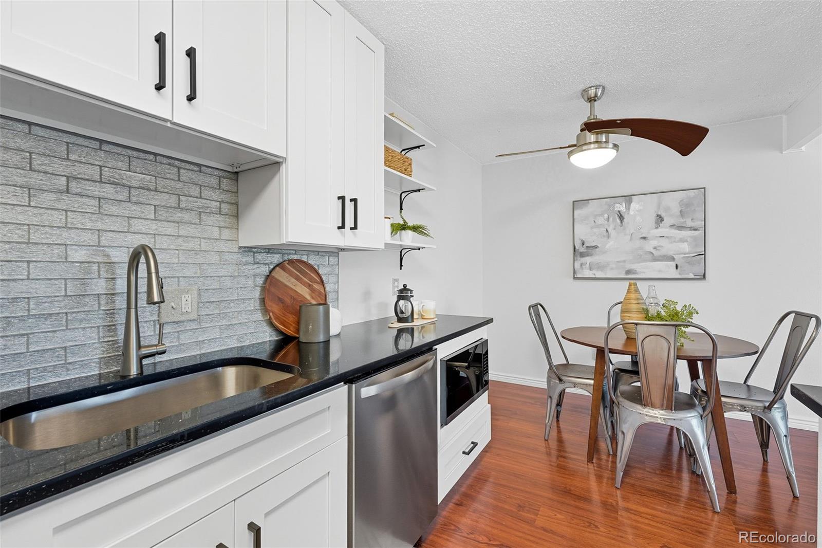 381 South Ames Street, Unit C204 Lakewood, CO 80226 - Photo 15 of 34 a kitchen with stainless steel appliances granite countertop a sink a stove and cabinets