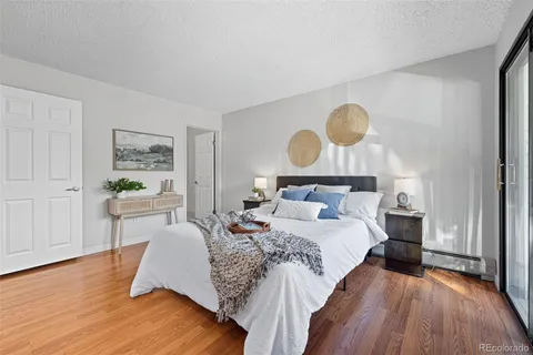 a bedroom with bed and wooden floor