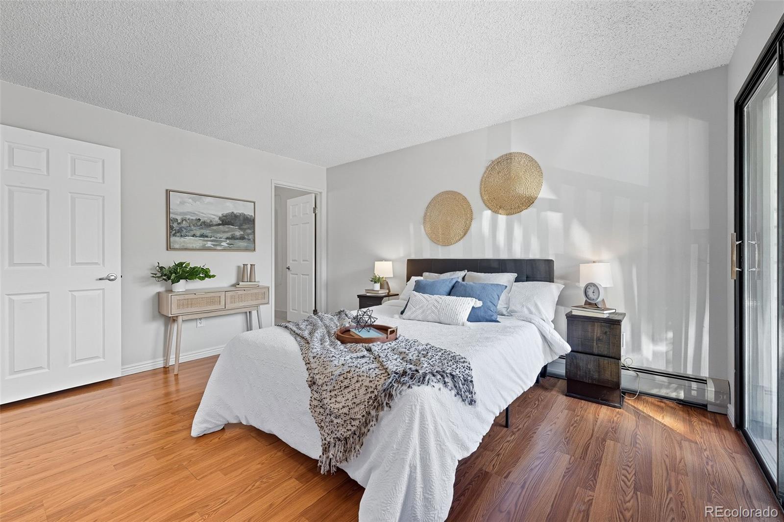 381 South Ames Street, Unit C204 Lakewood, CO 80226 - Photo 17 of 34 a bedroom with bed and wooden floor