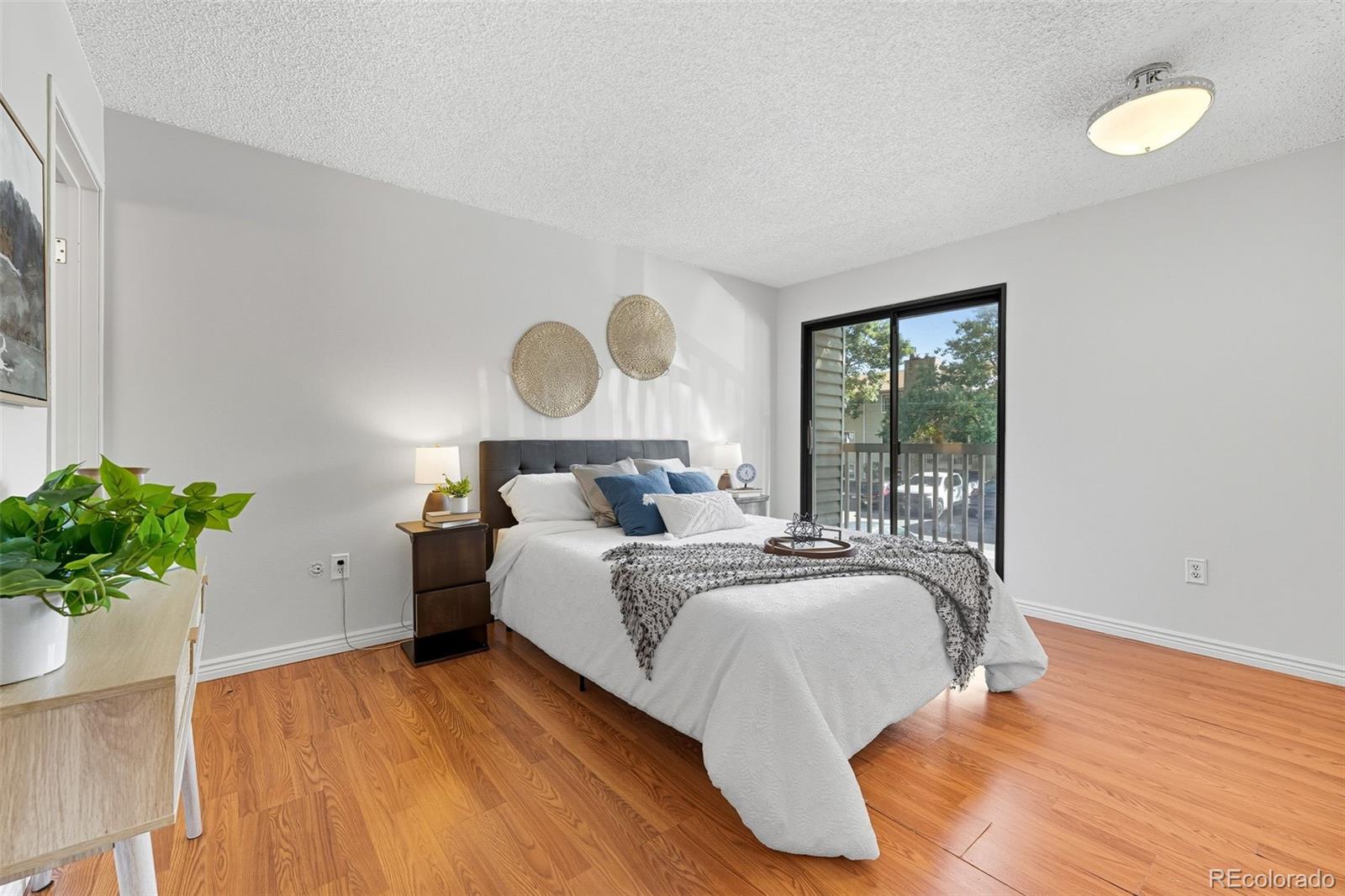 381 South Ames Street, Unit C204 Lakewood, CO 80226 - Photo 18 of 34 a bed room with a bed and a potted plant