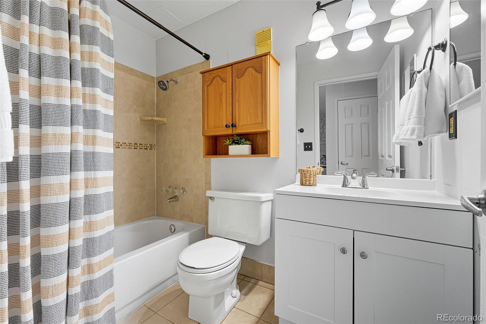 381 South Ames Street, Unit C204 Lakewood, CO 80226 - Photo 25 of 34 a bathroom with a sink a toilet and shower