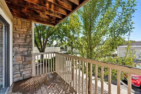 a balcony with wooden floor and outdoor space
