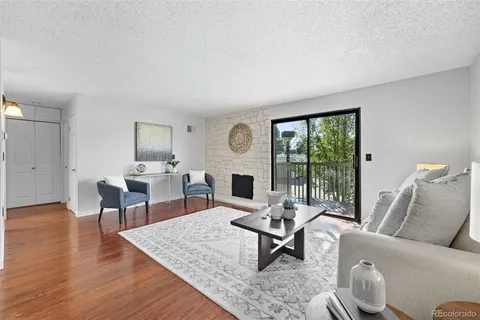 a living room with furniture a fireplace and a table