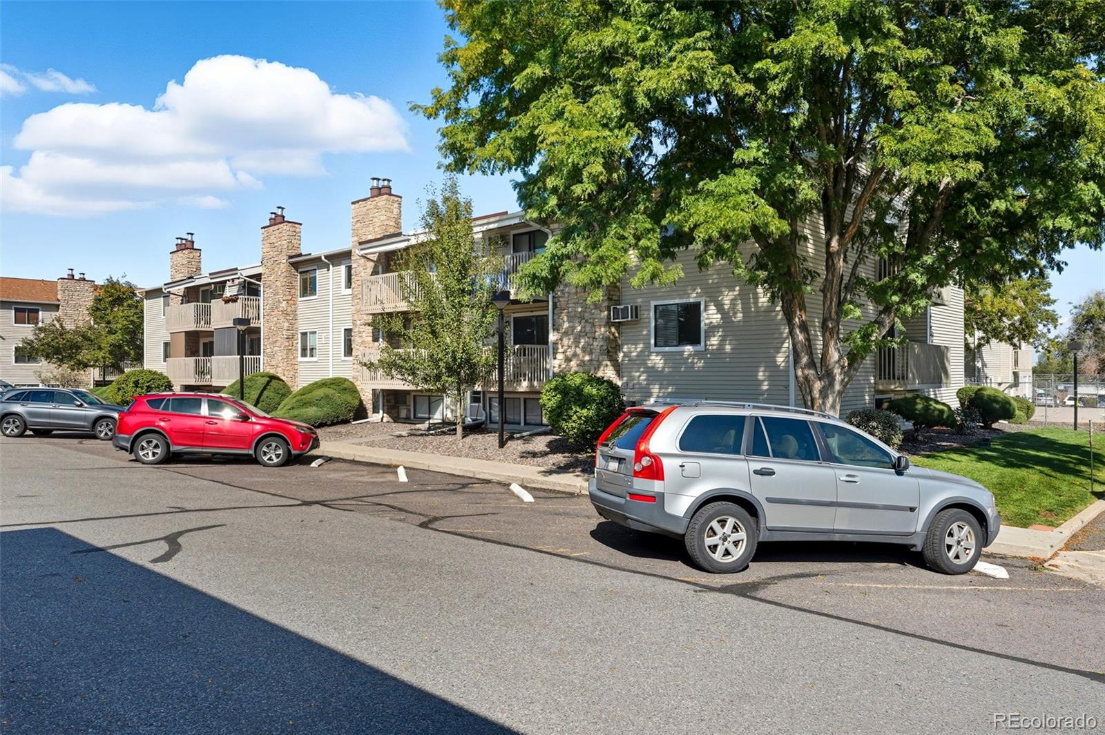 381 South Ames Street, Unit C204 Lakewood, CO 80226 - Photo 32 of 34 a view of cars parked in a parking lot