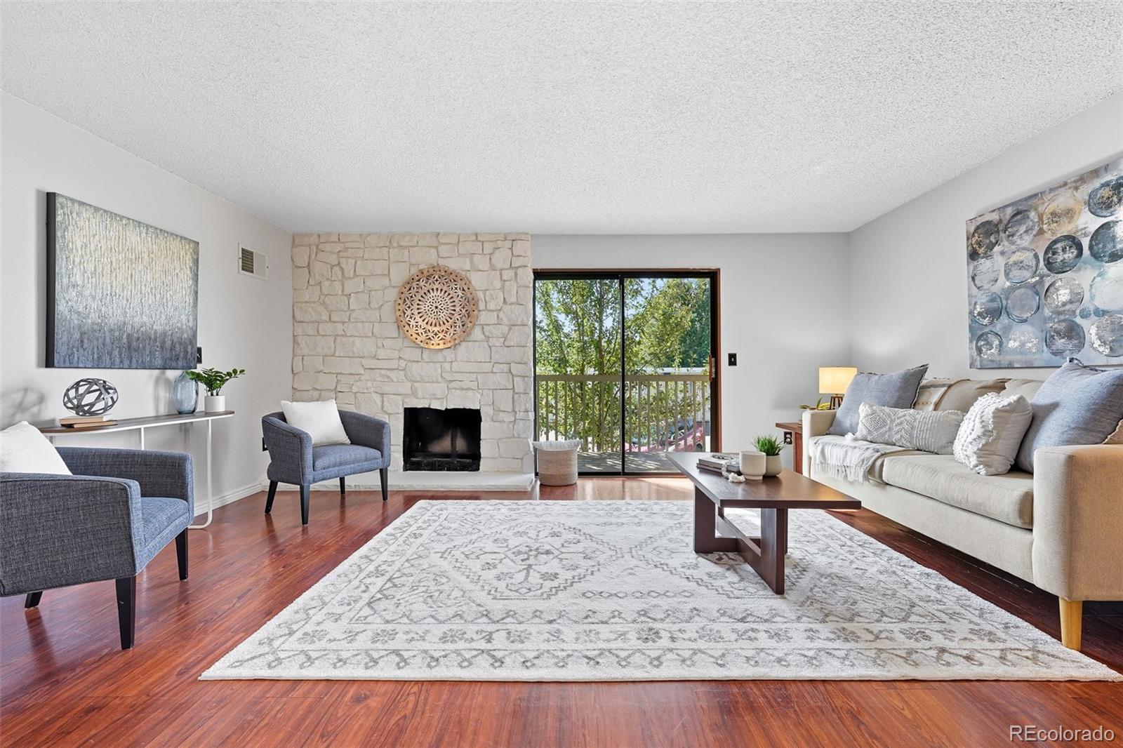 381 South Ames Street, Unit C204 Lakewood, CO 80226 - Photo 4 of 34 a living room with furniture and a fireplace