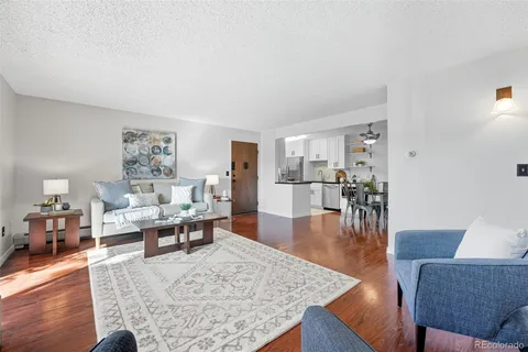 a living room with furniture wooden floor and a table
