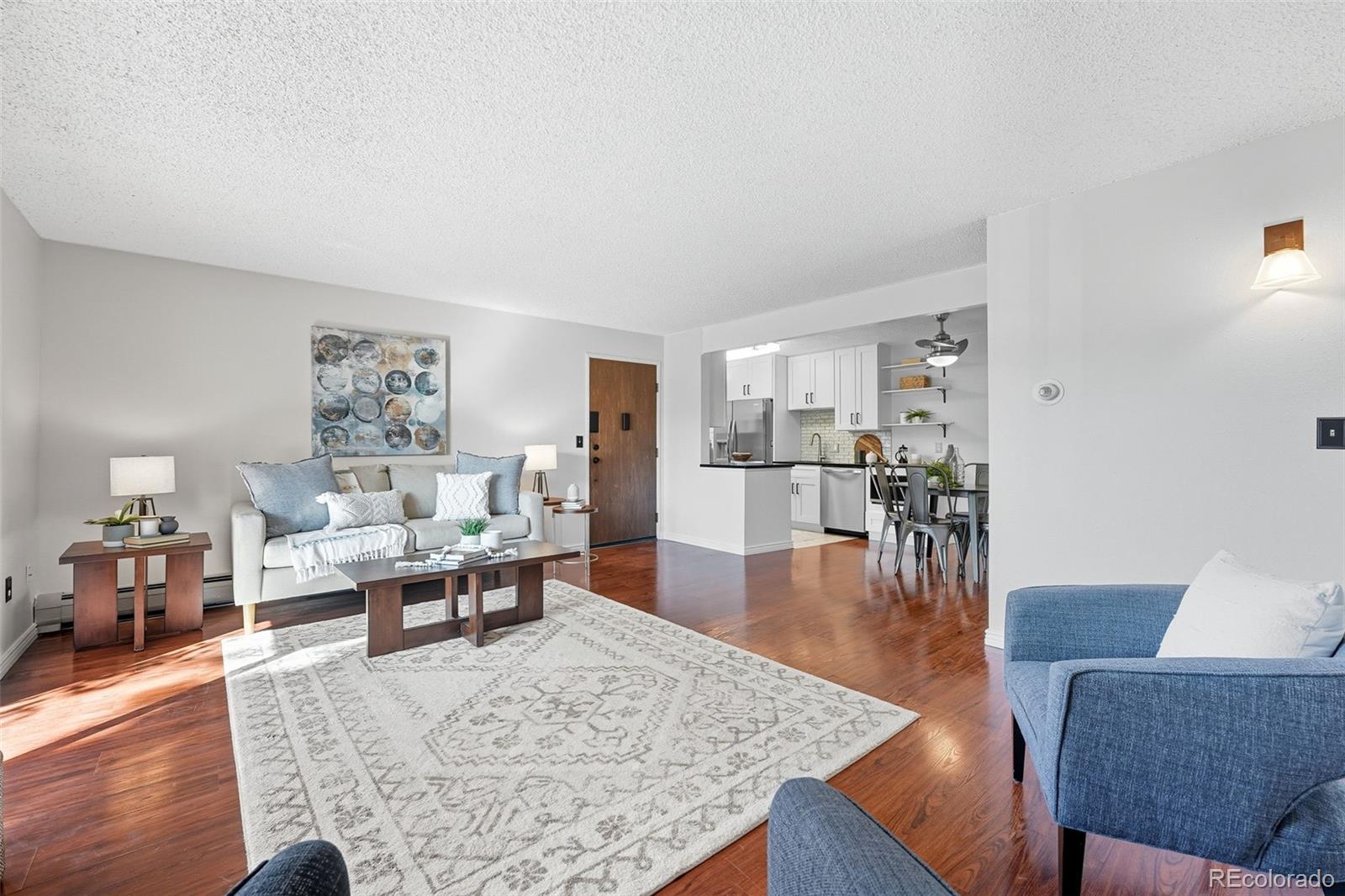 381 South Ames Street, Unit C204 Lakewood, CO 80226 - Photo 7 of 34 a living room with furniture wooden floor and a table