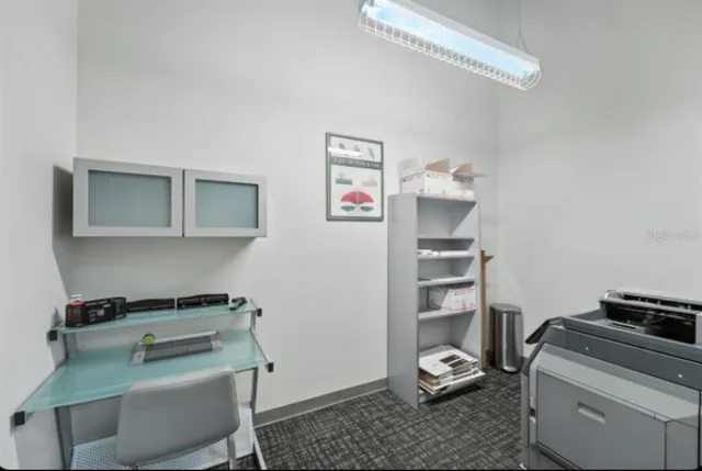 a bathroom with a granite countertop sink a toilet and a mirror
