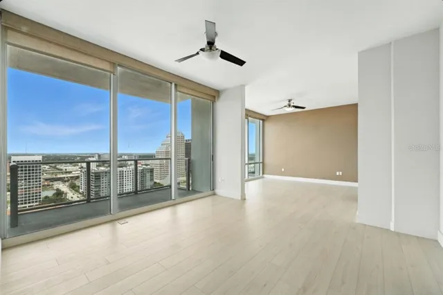 a view of a hallway with wooden floor and chandelier