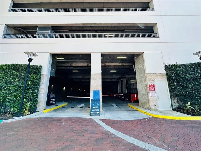 a living room with stainless steel appliances granite countertop furniture and a large window
