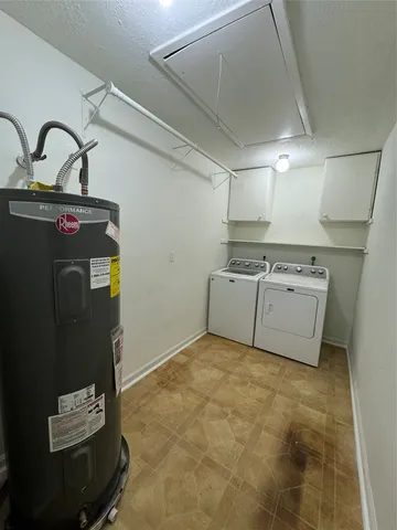 a view of a storage & utility room with cabinets