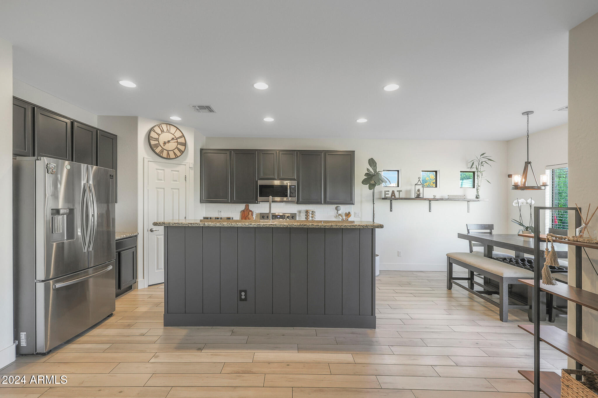 5220 West Beverly Road Laveen, AZ 85339 - Photo 10 of 49 a kitchen with stainless steel appliances granite countertop a refrigerator and a stove top oven