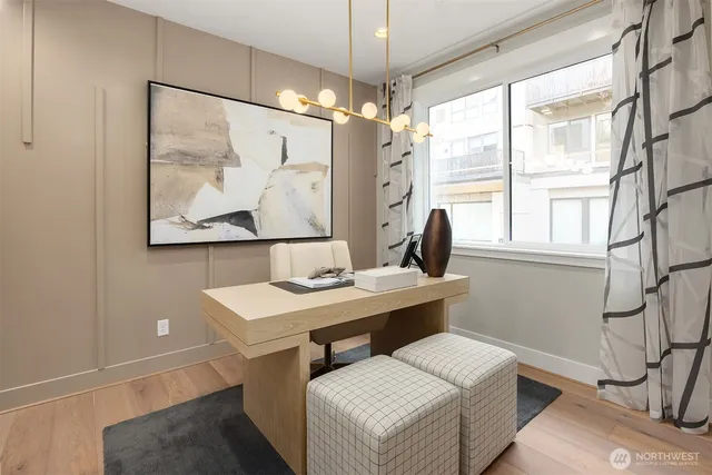 a view of a workspace with furniture and a window