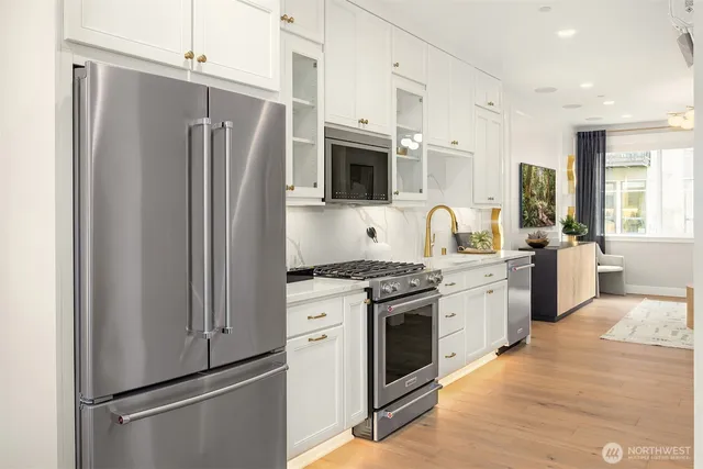 a kitchen with stainless steel appliances a refrigerator stove and sink