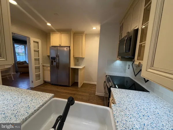 a kitchen with stainless steel appliances granite countertop a refrigerator and a sink