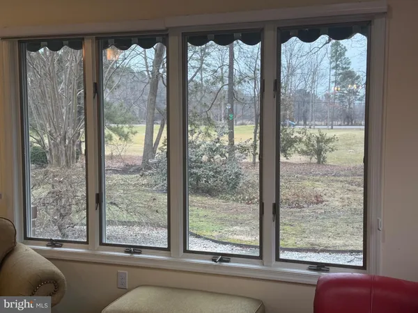 a view of a room that has a large window and a bed