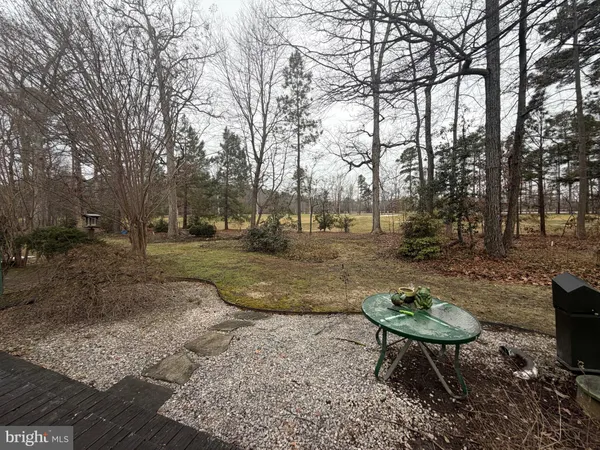a view of backyard with table and chairs and a fire pit