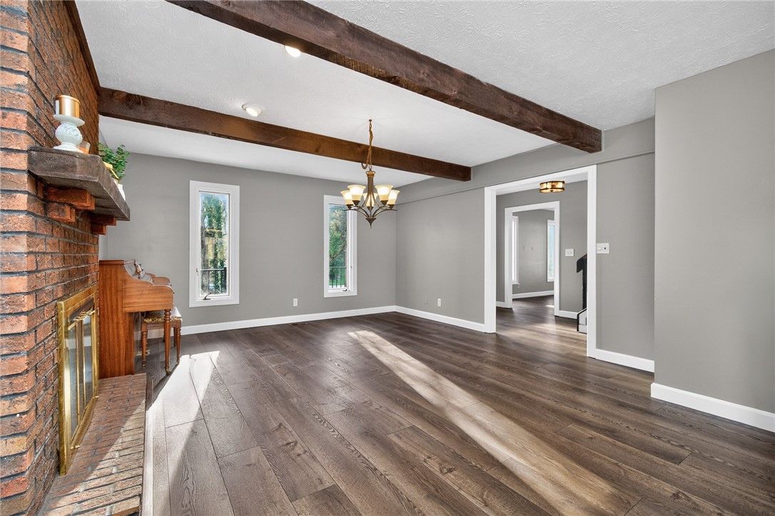 4747 Fawnwood Road Dayton, OH 45429 - Photo 12 of 58 This living area features a classic brick fireplace and elegant exposed ceiling beams.
