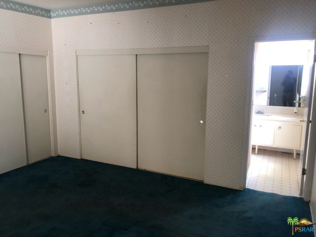 a view of an empty room with a kitchen