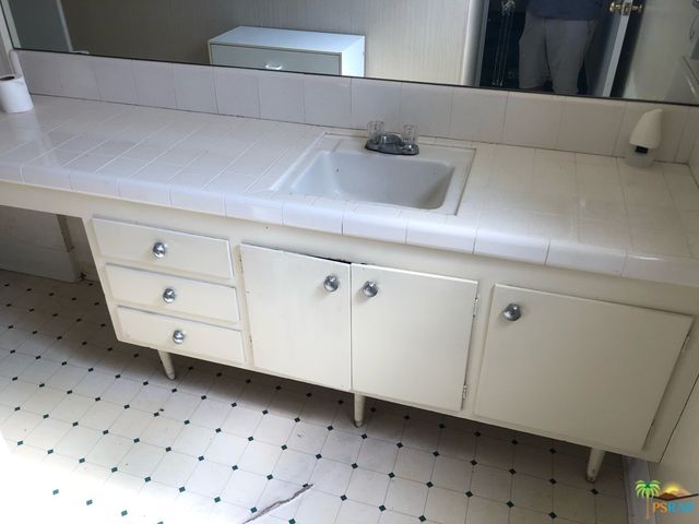 a close view of a sink and a dishwasher in a kitchen