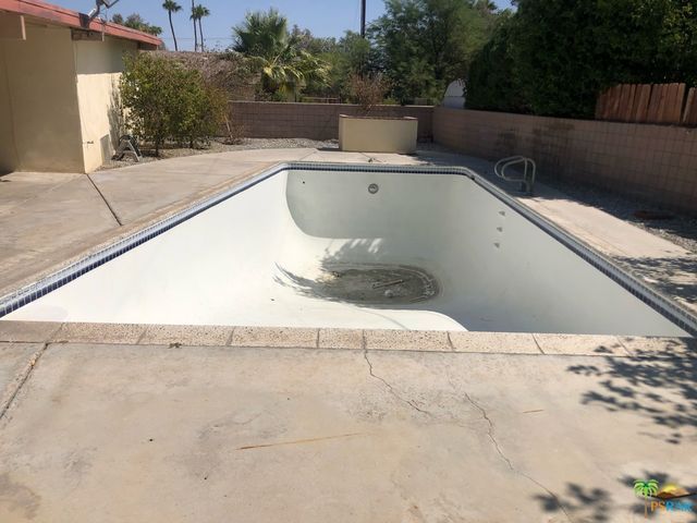 a view of a swimming pool with a yard