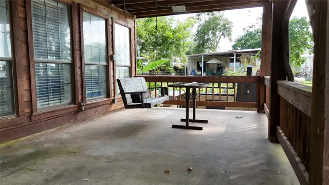 a view of a porch with furniture and a gate