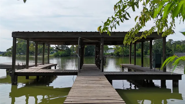 a view of a chairs and table in patio with a lake view