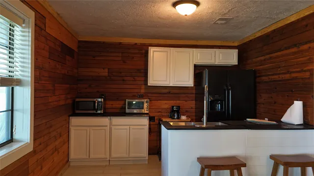 a kitchen with stainless steel appliances a sink stove and cabinets