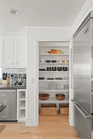 a bedroom with a bed window and a flat screen tv