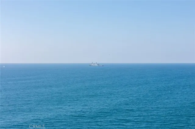 a view of hall way with furniture and chandelier