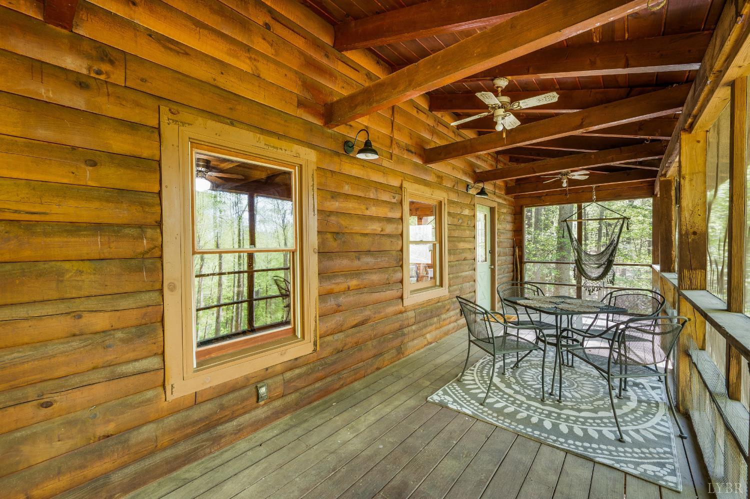 3882 Rocky Mountain Road Forest, VA 24551 - Photo 32 of 69 a view of a patio with table and chairs with wooden floor and floor to ceiling window