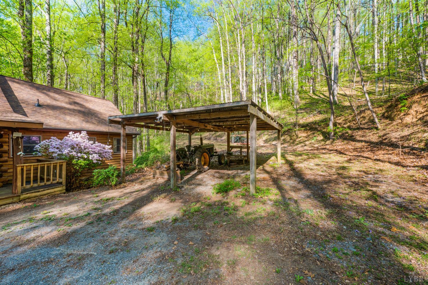 3882 Rocky Mountain Road Forest, VA 24551 - Photo 43 of 69 a view of a patio with table and chairs under an umbrella