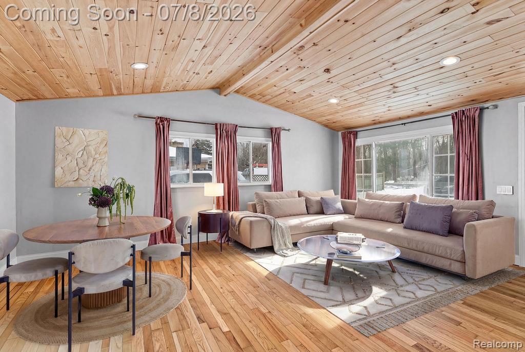 5698 McGrandy Road Bridgeport, MI 48722 - Photo 8 of 26 Open-concept living area featuring wood-finish plank ceilings with recessed lighting, light wood-finish flooring, multiple windows, and light gray wall paint