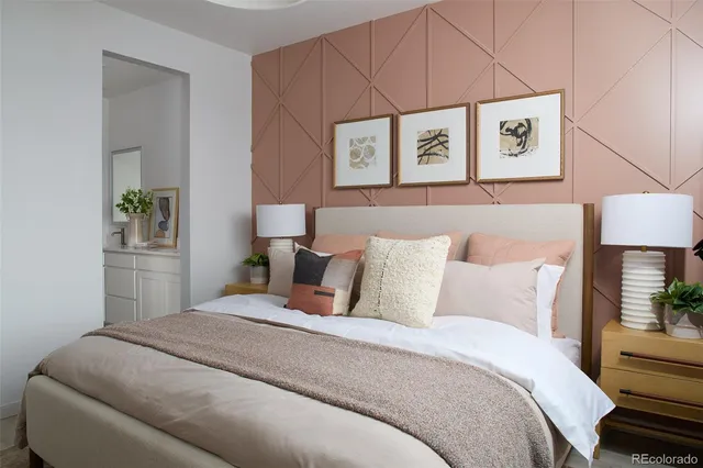 a bedroom with a bed and a lamp on dresser