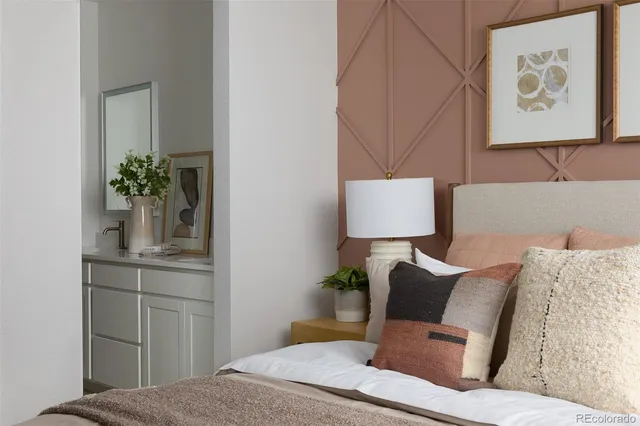 a bedroom with a bed and a potted plant