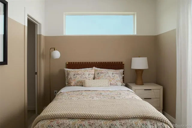 a bedroom with a bed and a night stand