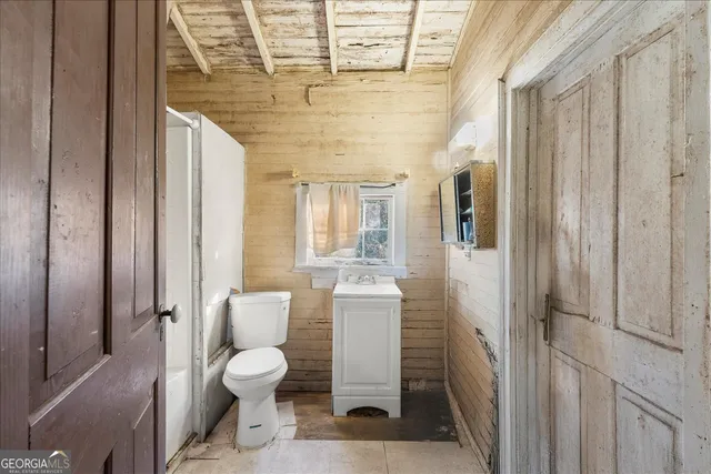 a bathroom with a toilet a sink and shower