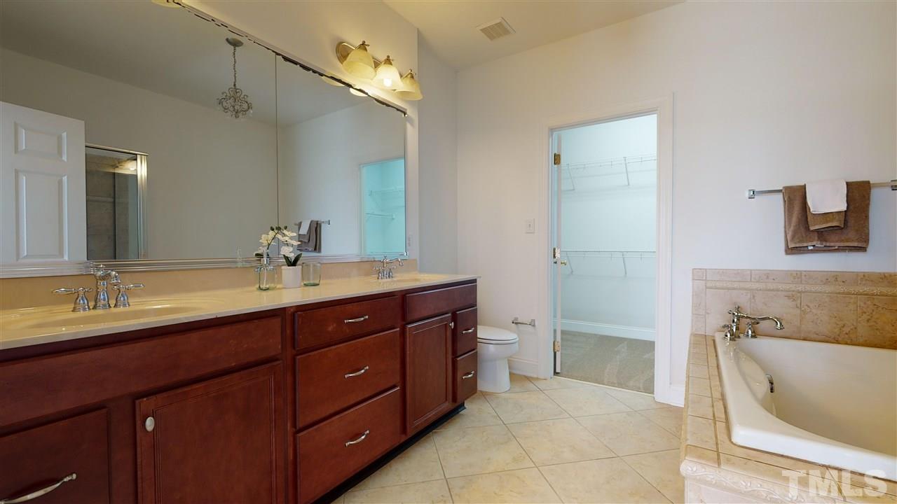 11245 Maplecroft Court Raleigh, NC 27617 - Photo 10 of 30 Generous 1st Floor Master Suite w/ luxurious garden tub, dual vanity, glass/tile shower, & oversized WIC.